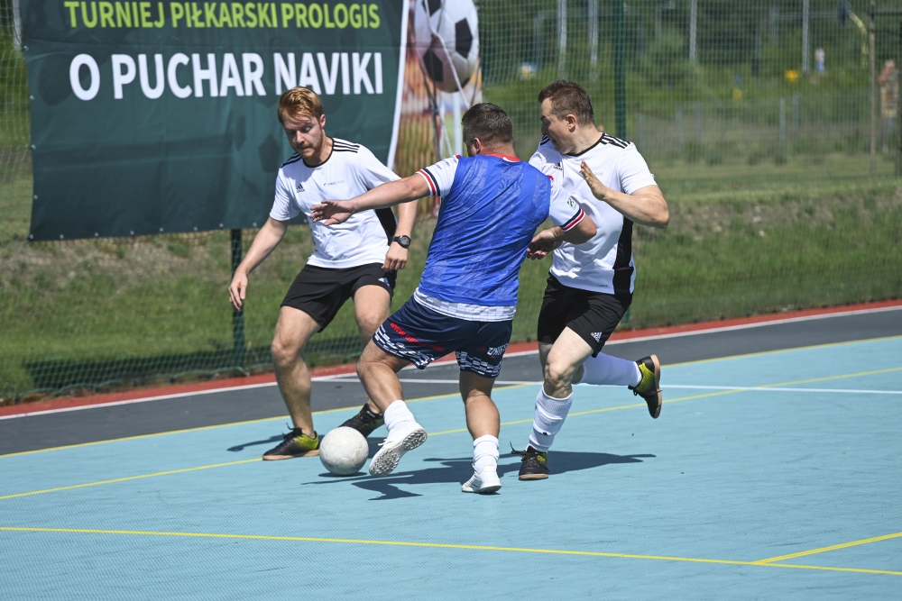 Three football players on the field